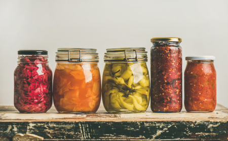 Jars of preserved food showing correctly pressure canned product used as a header for a blog page on pressure canning.